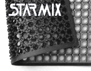 Detalhe do canto de um tapete ergonômico antifadiga STARMIX em borracha preta, com superfície de bolhas em relevo e base vazada em grade para drenagem, borda em rampa.